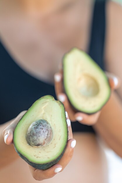 Free Photo pregnant woman holding avocado health and maternity concept