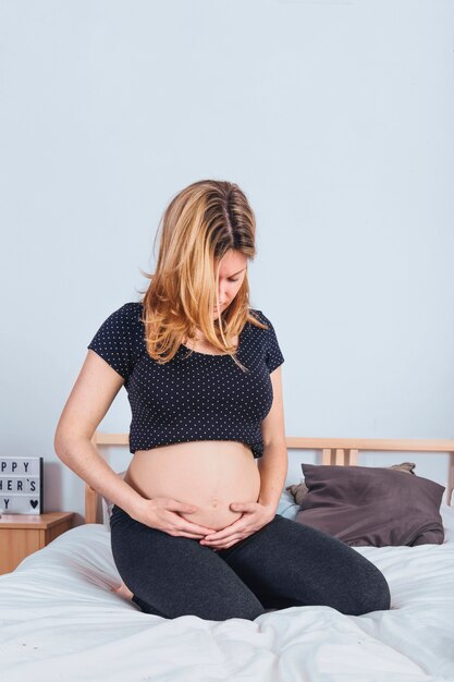 Pregnant woman holding belly