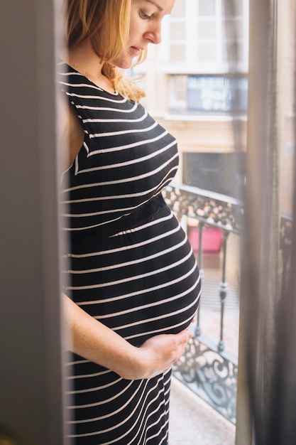 Pregnant woman holding belly