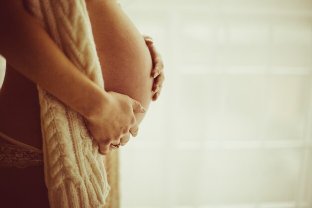 Pregnant woman holding her belly