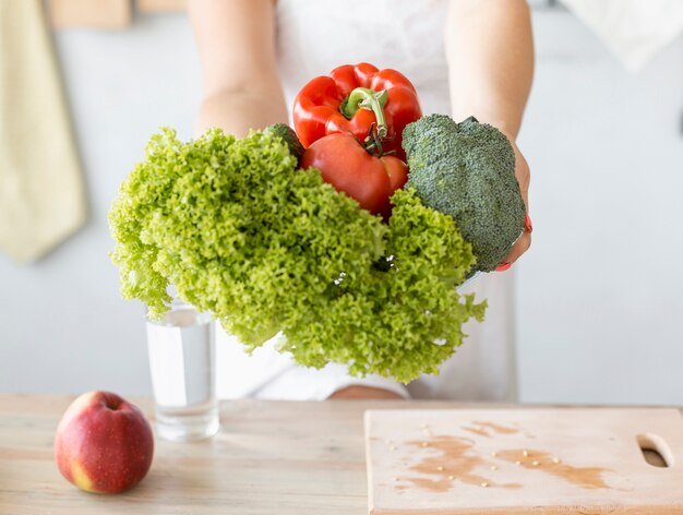 Pregnant woman holding vegetables