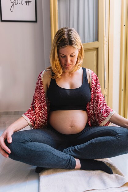 Pregnant woman next to open window