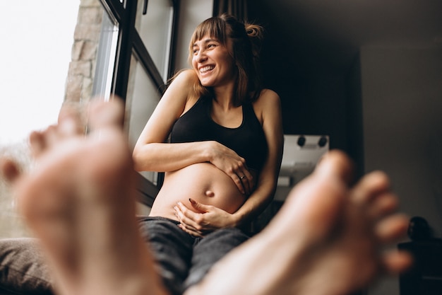 Pregnant woman sitting by the window