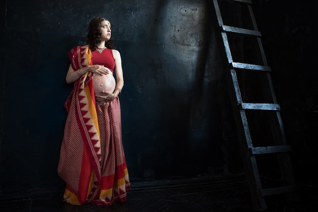 Free photo pregnant woman with henna tattoo