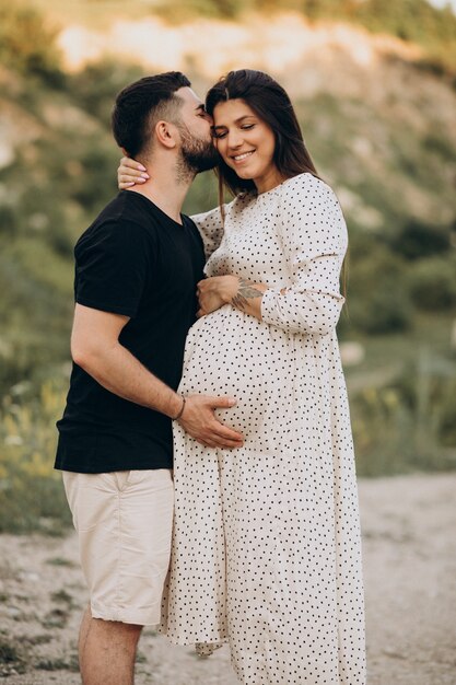 Pregnant woman with her husband in park