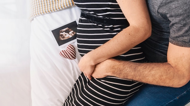 Pregnant woman with husband and ultrasound