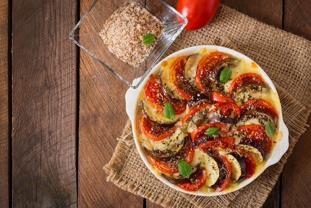 Prepared gratin dish raw eggplant with mozzarella and tomatoes