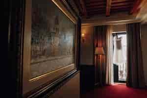 Free photo prepared wedding dress in an empty room of the hotel