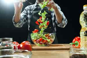 Free photo preparing salad. female chef cutting fresh vegetables. cooking process. selective focus. the healthy food, kitchen, salad, diet, cuisine organic concept