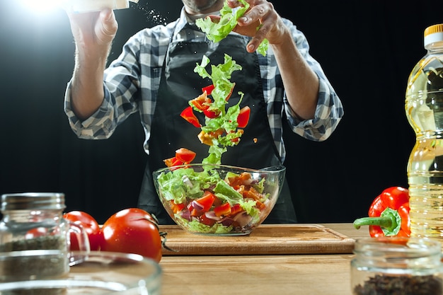 Free Photo preparing salad. female chef cutting fresh vegetables. cooking process. selective focus. the healthy food, kitchen, salad, diet, cuisine organic concept