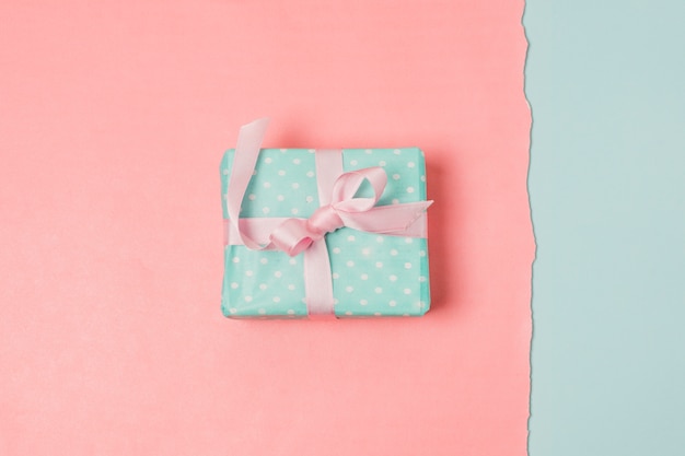 Present box over blue and peach backdrop