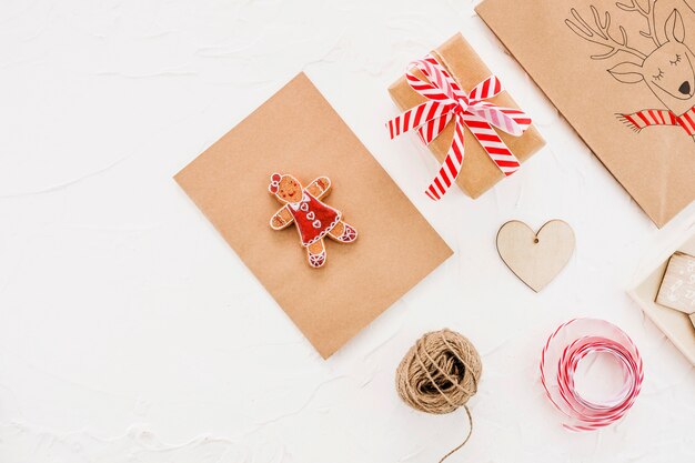 Present box near threads and brown tablet with toy 