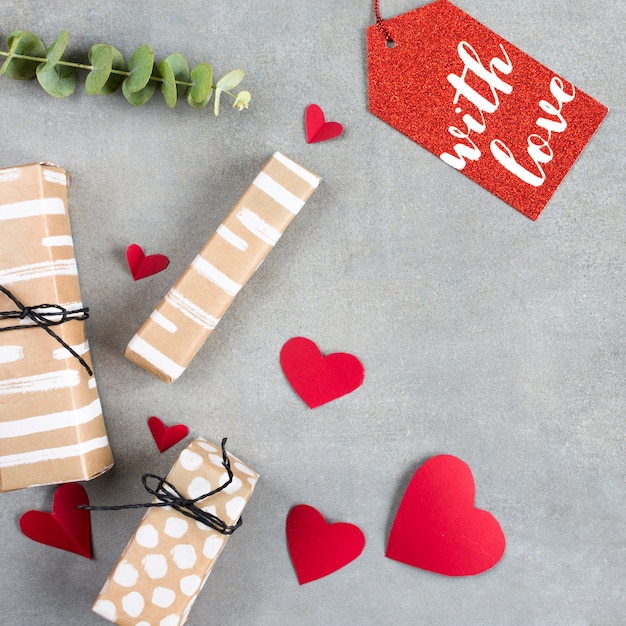 Present boxes near paper hearts and tag 