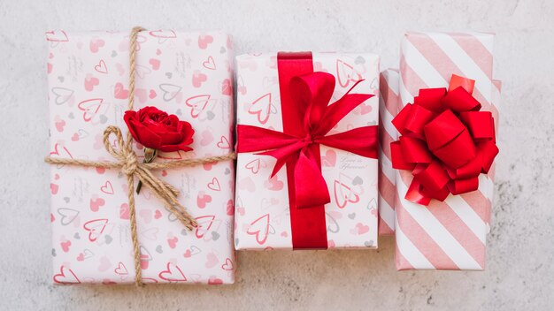 Present boxes in wrap with flower, ribbon and bow