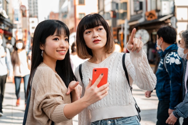 Pretty asian girls together outdoors