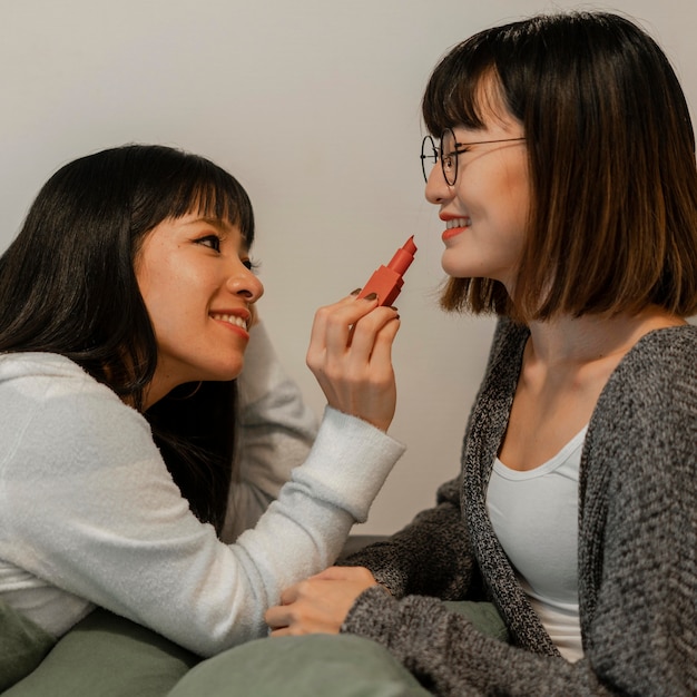 Pretty asian girls trying out make up products