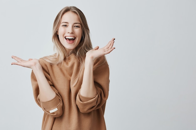 Pretty beautiful woman with blonde long hair having excited and happy facial expression