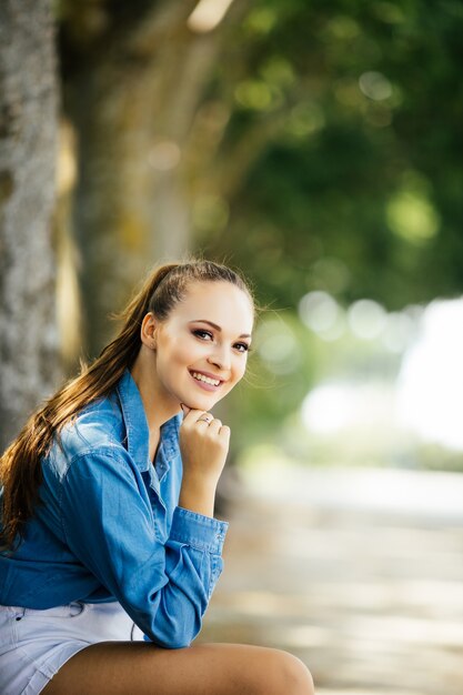 Pretty beautiful young woman resting in park