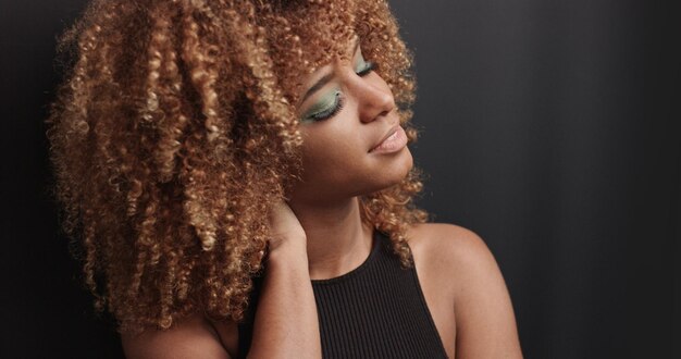 Pretty black girl with big hair posing video on black background