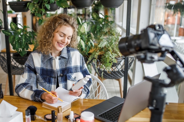 Pretty blonde influencer testing new products on the camera