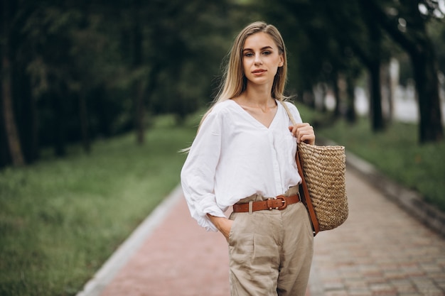 Free Photo pretty blonde woman in park wearing summer look