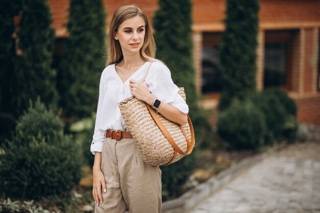 Pretty blonde woman in park wearing summer look