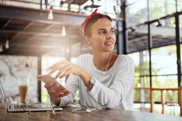 Pretty blonde woman sitting in cafe