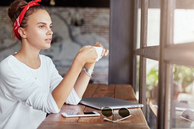 Pretty blonde woman sitting in cafe