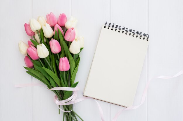  Pretty bouquet of tulips flowers with empty notebook