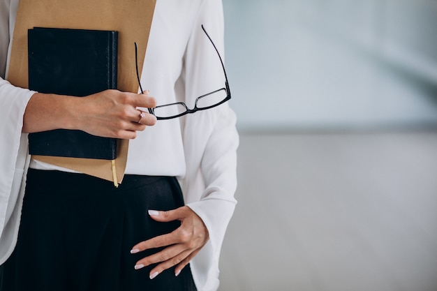 Pretty business woman holding folder