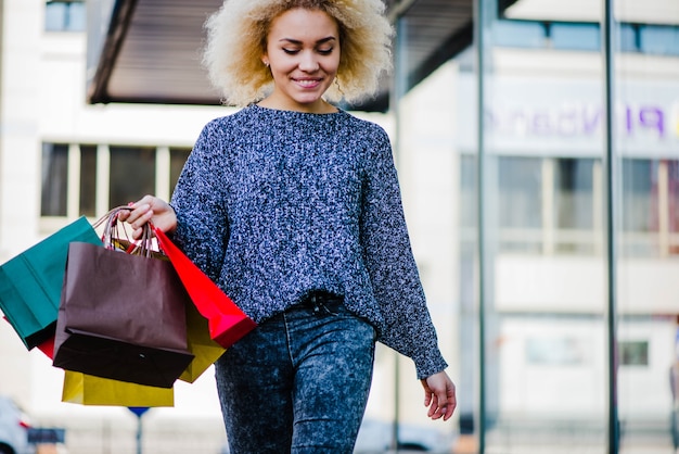 Pretty casual dressed shopper on street