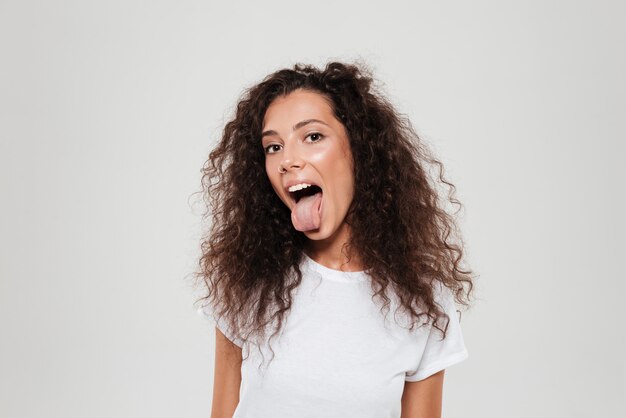 Pretty curly woman with tongue out