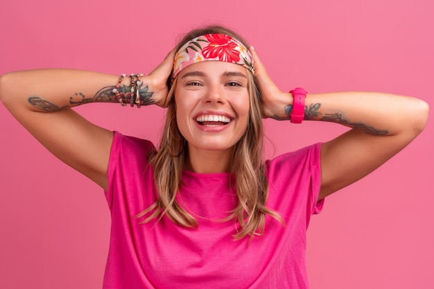 Free photo pretty cute smiling woman in pink shirt boho hippie style accessories smiling emotional fun posing on pink isolated