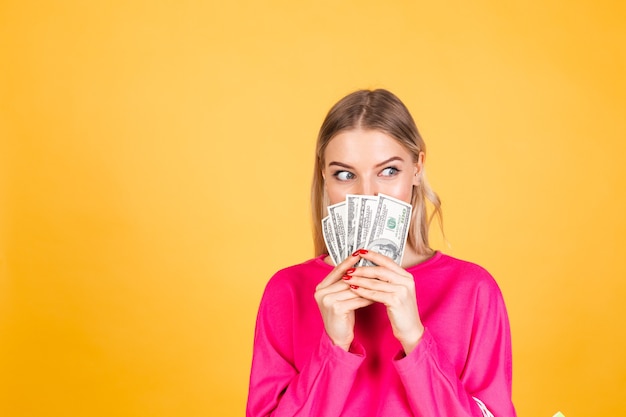 Free photo pretty european woman in pink blouse on yellow wall