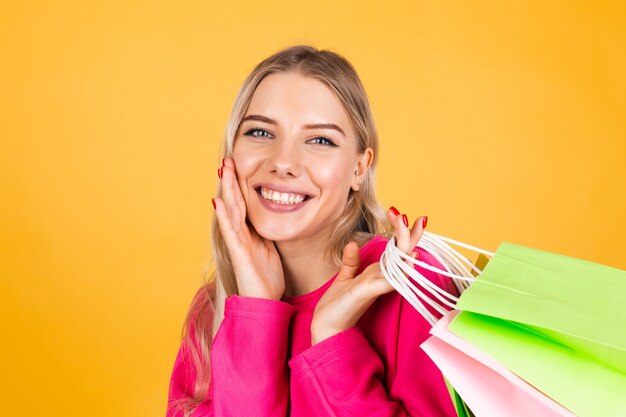 Free Photo pretty european woman in pink blouse on yellow wall