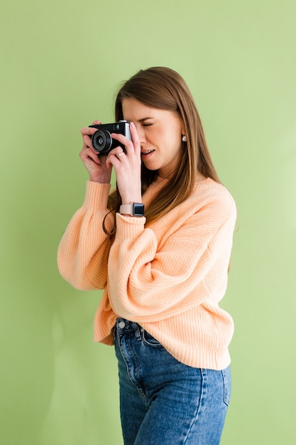 Free photo pretty european woman with photo camera in hands positive smile happy