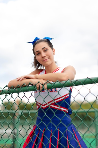 Pretty female cheerleader in cute uniform