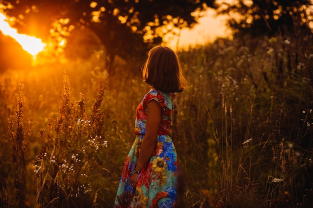 Free Photo pretty girl in a bright dress poses on the field 