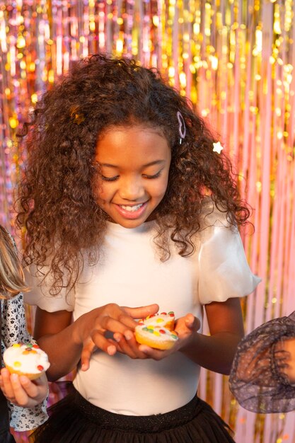 Pretty girl at festive party holding cupcake