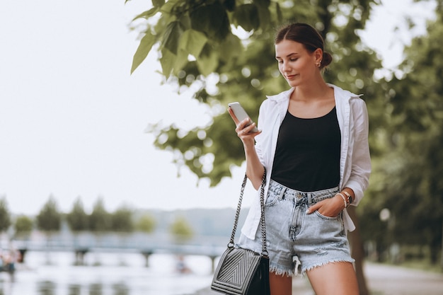 Free photo pretty girl in park using phone