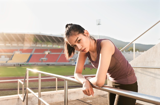 Pretty girl posing with stadium background