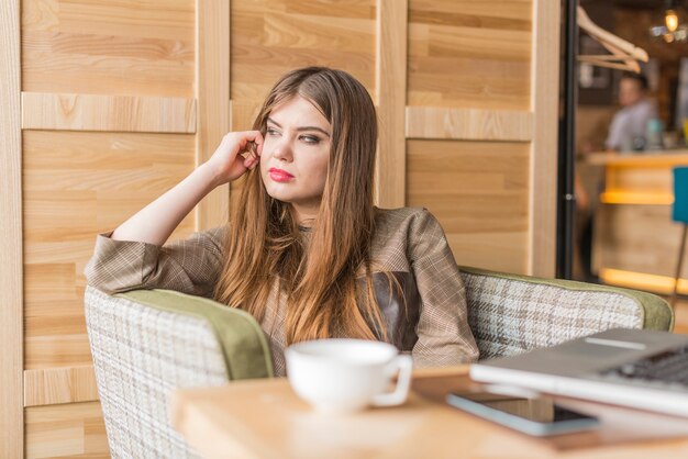 Pretty girl spending the afternoon in a coffee shop