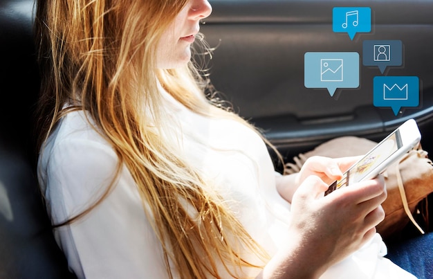 Free Photo pretty girl using her phone in a car