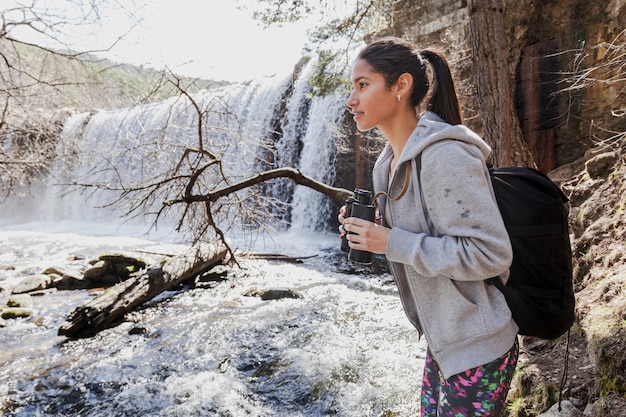 Pretty girl with binoculars outdoors