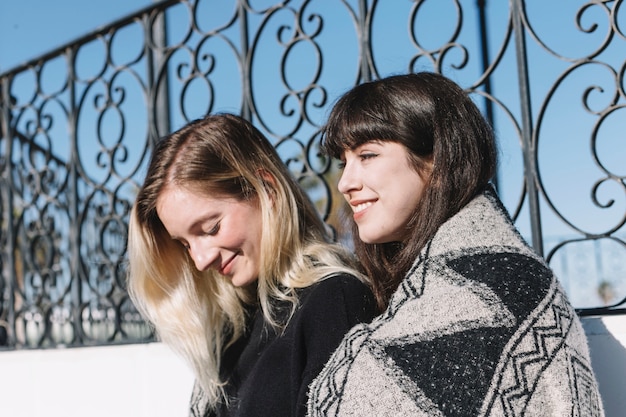 Pretty girlfriends in plaid outside