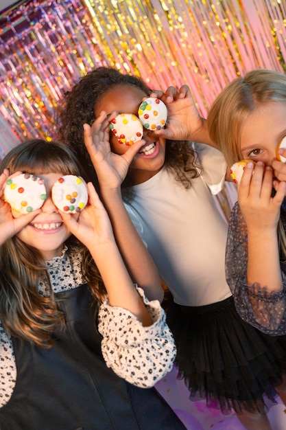 Free photo pretty girls at festive party holding cupcakes