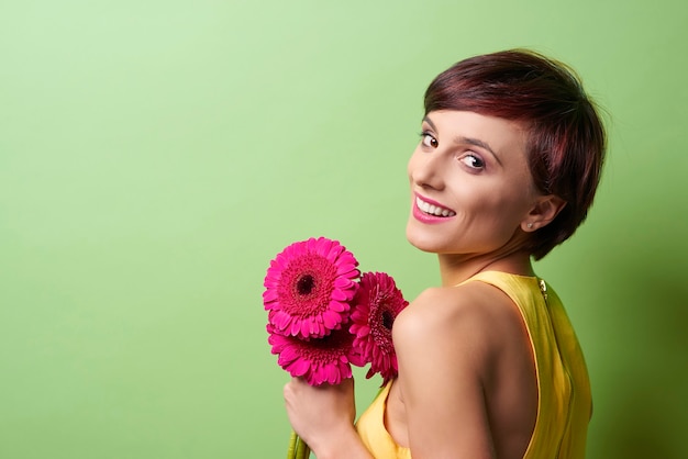 Pretty lady holding bunch of flowers