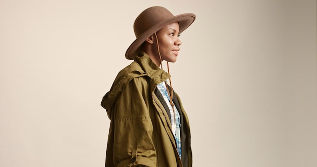 Pretty mixed race woman with short hair in autumn outwear and hat