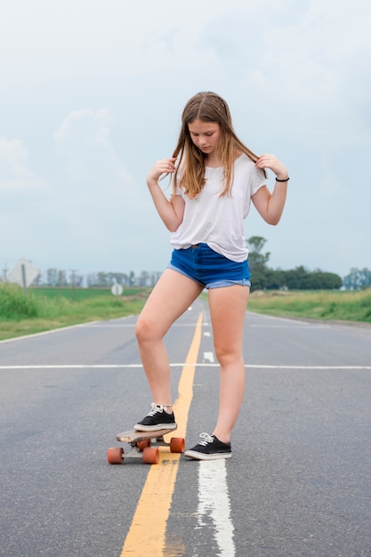 Pretty modern girl staking on empty street