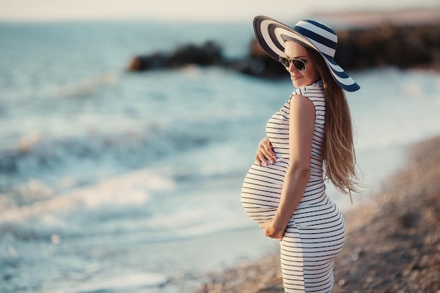 pretty pregnant woman near the sea